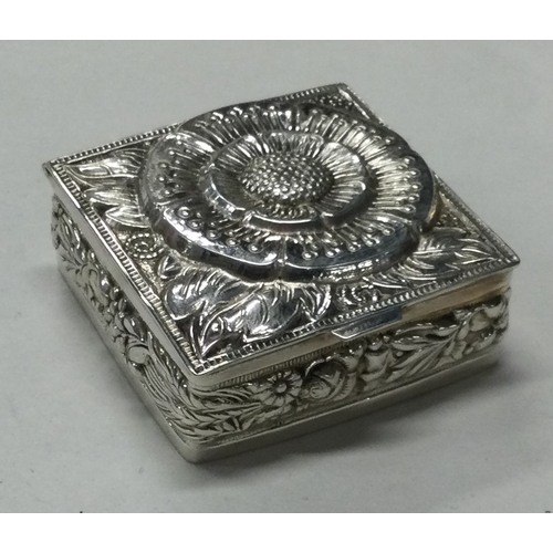 82 - A square engraved silver hinged pill box. Marked to side. Approx. 28 grams. Est. £30 - £50.