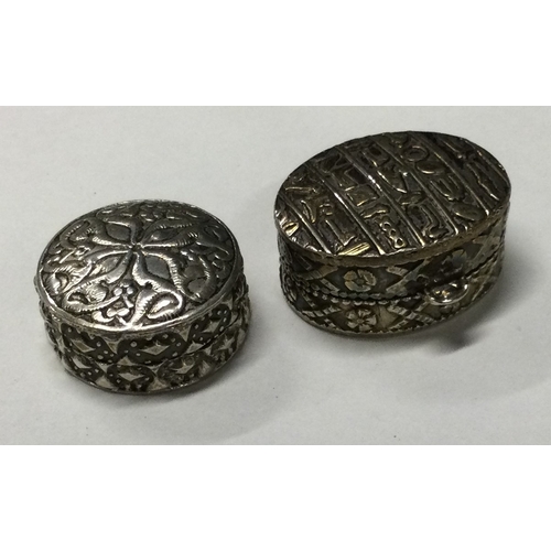 83 - Two circular chased silver pill boxes with lift-off covers. Marked to bases. Approx. 32 grams. Est. ... 