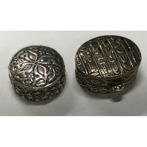 83 - Two circular chased silver pill boxes with lift-off covers. Marked to bases. Approx. 32 grams. Est. ... 