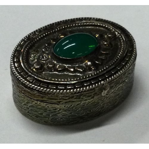 88 - A silver pill box with hinged cover and green stone to centre. Marked to base. Approx. 27 grams. Est... 