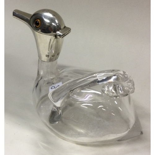 90 - A novelty Victorian silver and glass claret jug in the form of a duck. Birmingham 1899. Approx. 352 ... 