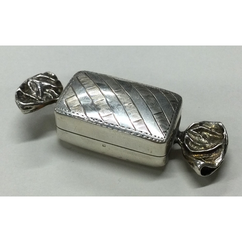 92 - A silver hinged pill box in the form of a sweet. Marked to side. Approx. 17 grams. Est. £20 - £30.