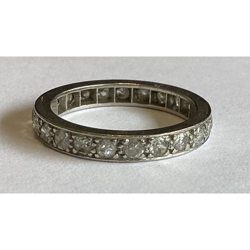 843 - A platinum mounted diamond full eternity ring of typical form. Approx. 5 grams. Est. £200 - £300.