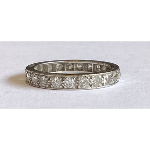 843 - A platinum mounted diamond full eternity ring of typical form. Approx. 5 grams. Est. £200 - £300.