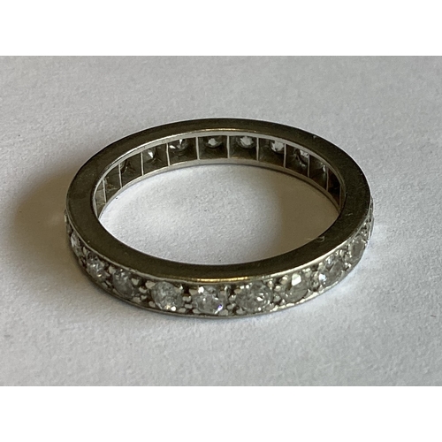 843 - A platinum mounted diamond full eternity ring of typical form. Approx. 5 grams. Est. £200 - £300.