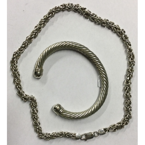 560 - A heavy silver necklace together with a torque bangle. Approx. 88 grams. Est. £30 - £50.