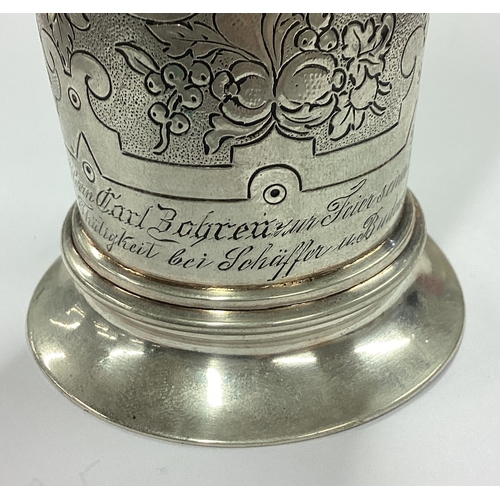 111 - A German silver beaker with coin inserts. Approx. 200 grams. Est. £300 - £400.