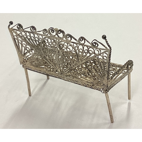 117 - A silver filigree toy chair. Approx. 4 grams. Est. £20 - £30.