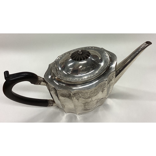 129 - An 18th Century Georgian silver teapot with bright-cut decoration. London 1788. By John Robins. Appr... 