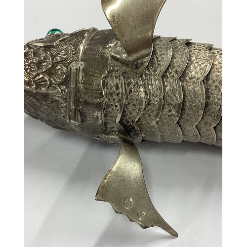 134 - A large Antique silver articulated fish hinged spice box with green eyes. Approx. 142 grams. Est. £2... 