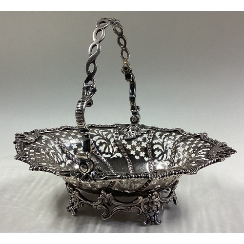 15 - An 18th Century Georgian silver swing handled basket with pierced decoration. London 1763. Approx. 1... 