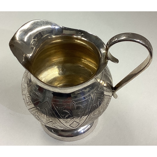 17 - A 19th Century Russian silver jug with chased decoration. 1884. Marked to base. Approx. 133 grams. E... 