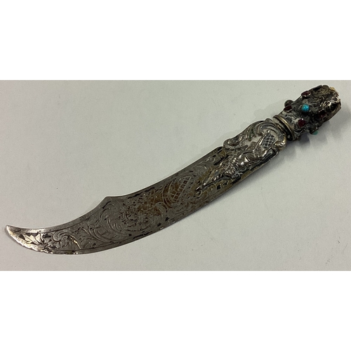 19 - A Continental silver letter opener in the form of a sword with blue stones and knight decoration. Ap... 