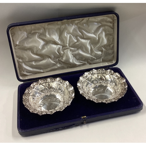 226 - A fine pair of cased Victorian silver bowls with chased decoration. Sheffield 1898. By Henry Wilkins... 