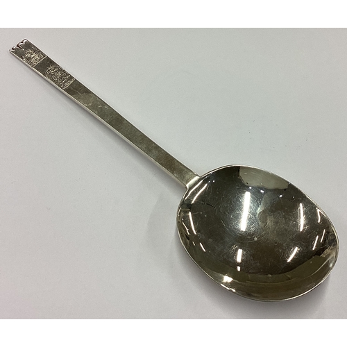 229 - An early style silver bottom marked spoon with double crest to terminal. London 1937. Approx. 44 gra... 