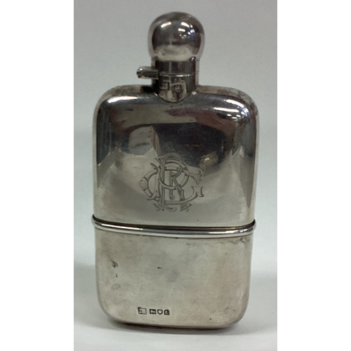 295 - A good shaped silver hinged top hip flask with removable cup. London. By SM&Co. Approx. 145 grams. E... 