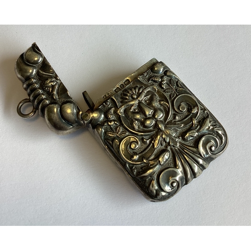 329 - A chased Victorian silver vesta case decorated with a face. Birmingham 1891. Approx. 32 grams. Est. ... 