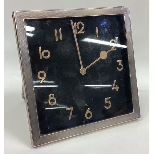 340 - A large stylish silver mounted clock with engine turned decoration. Approx. 730 grams of gross weigh... 