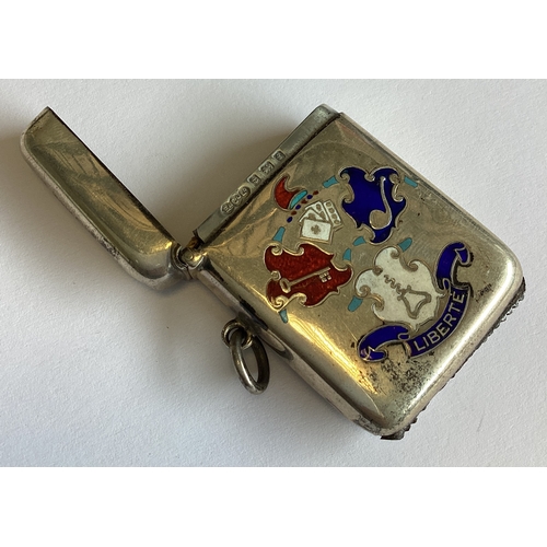 367 - A silver and enamelled vesta case with central armorial and Liberté decoration. Birmingham 1905.  Ap... 