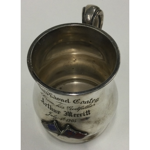 386 - A silver and enamelled mug embossed with American and Australian flags. Marked Sterling to base. App... 