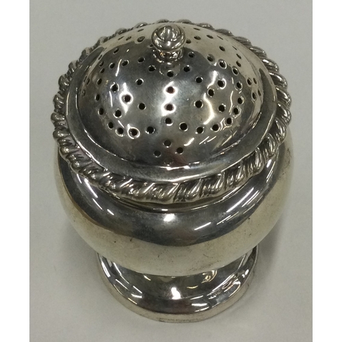 389 - An Irish silver caster with pull-off cover. Approx. 86 grams. Est. £80 - £120.