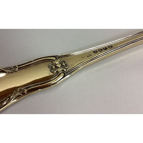 421 - A heavy fine quality silver gilt hour glass pattern basting spoon. London. By WE,WF&WC. Approx. 211 ... 