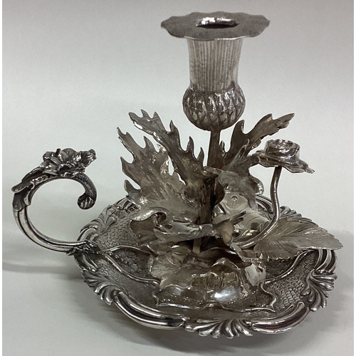 428 - A fine quality frosted silver chamberstick profusely decorated with flowers and leaves. London 1833.... 