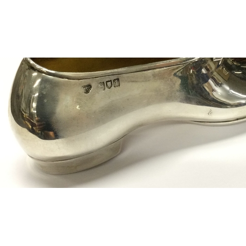 436 - A large novelty silver model of a child's shoe. London 1910. By Goldsmiths & Silversmiths. Approx. 8... 