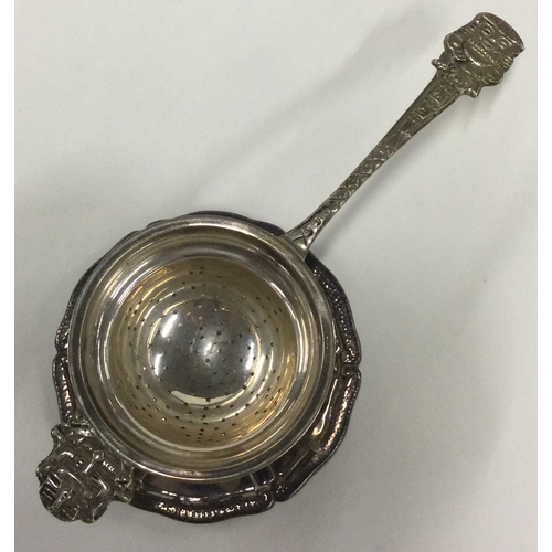 455 - A large Continental silver tea strainer on stand. Marked 900. Approx. 100 grams. Est. £100 - £150.