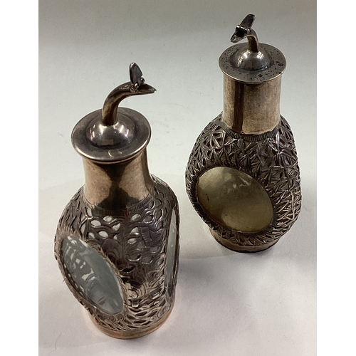 481 - A pair of Chinese silver and glass decanters embossed with bamboo decoration. Marked Sterling. Appro... 