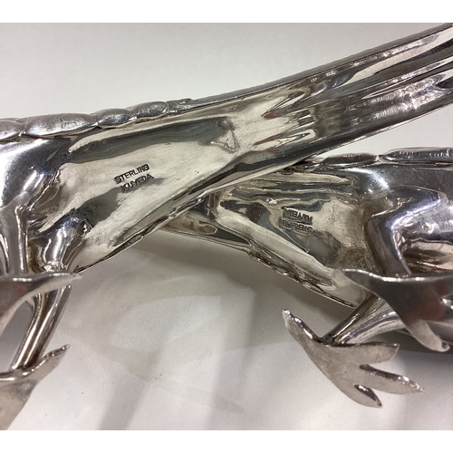 488 - A pair of silver pepperettes in the form of pheasants with screw-top covers. Marked to bases. Approx... 