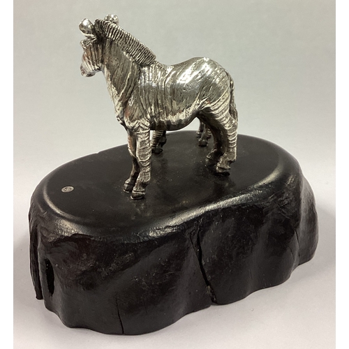 491 - PATRICK MAVROS: A silver zebra and foal sculpture on blackwood base. Approx. 234 grams of gross weig... 