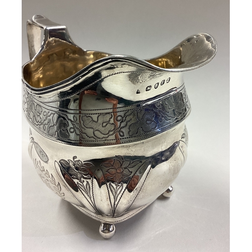 492 - An 18th Century Georgian silver cream jug with fine bright-cut decoration. Approx. 153 grams. Est. £... 