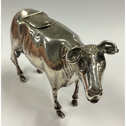 494 - An Antique silver cow creamer with hinged cover. Marked to lid. Approx. 90 grams. Est. £300 - £400.