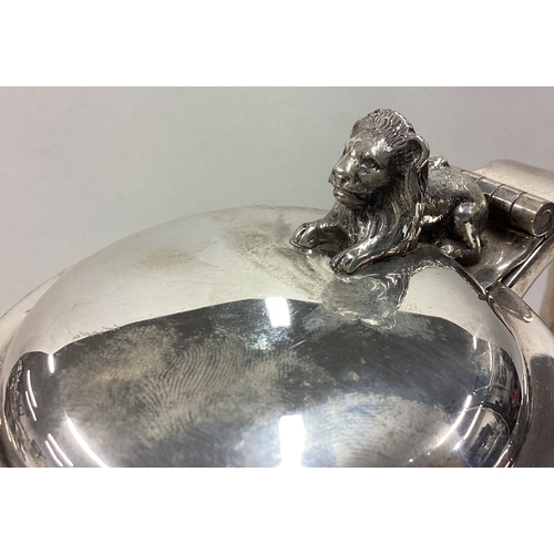 505 - A fine silver lidded beer tankard with hinged lid cast with lion. Fully marked to base and part mark... 