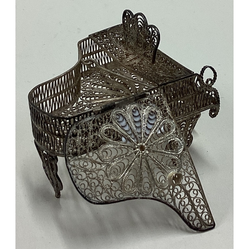 511 - A silver filigree toy model of a piano with hinged cover. Approx. 17 grams. Est. £20 - £30.