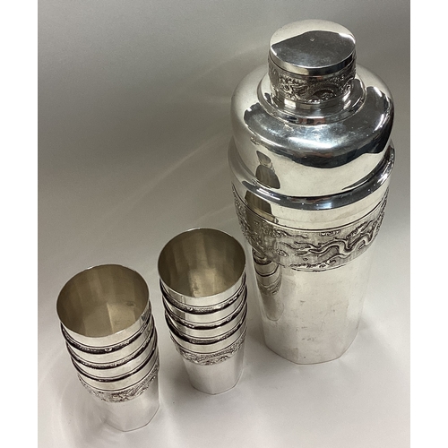 527 - A large Chinese silver cocktail shaker with eight beakers. Approx. 600 grams. Est. £500 - £800.