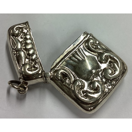 585 - A chased silver vesta case. Approx. 11 grams. Est. £20 - £30.