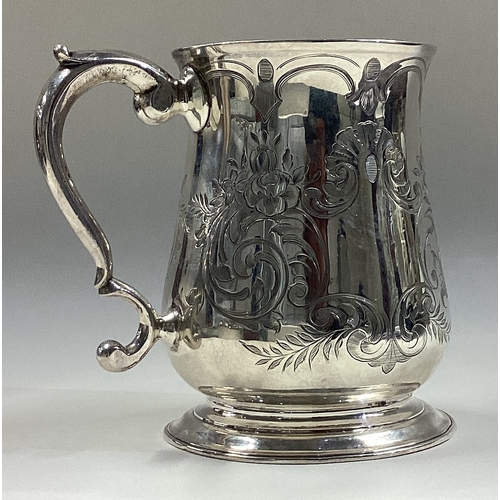 6 - An 18th Century silver tankard with engraved decoration. London 1758. By R Cox. Approx. 200 grams. E... 