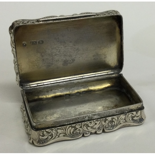 615 - A good quality Victorian silver snuff box with scroll decoration. Birmingham. By FM. Approx. 110 gra... 