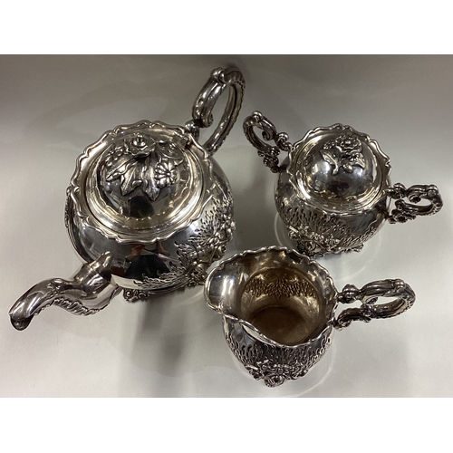 641 - An early 19th Century Chinese export silver tea set embossed with flowers and characters. Marked to ... 