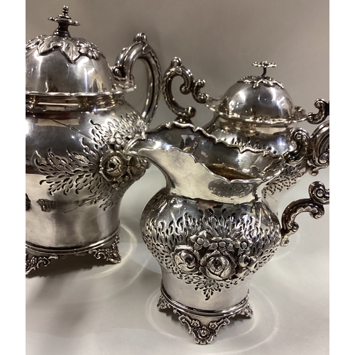 641 - An early 19th Century Chinese export silver tea set embossed with flowers and characters. Marked to ... 