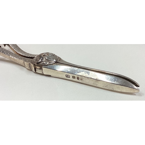 653 - A cased pair of late Victorian silver grape scissors. Birmingham. Approx. 74 grams. Est. £100 - £150... 