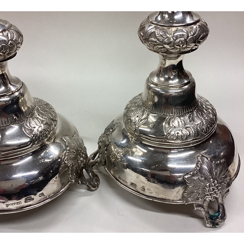 663 - A large pair of Judaica silver candlesticks on feet chased with flowers and vines. Circa 1890. Appro... 