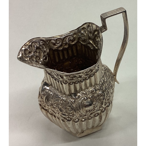 668 - A chased silver jug. Birmingham 1896. Approx. 57 grams. Est. £80 - £120.