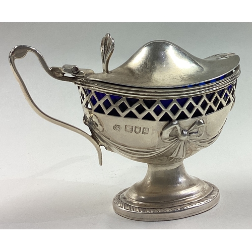 672 - An ornate pierced silver mustard pot with BGL chased with swag decoration. London 1902. By William H... 