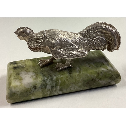 69 - A silver figure of a bird on green stone base. Approx. 390 grams. Est. £200 - £250.