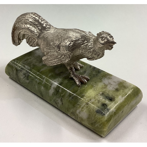 69 - A silver figure of a bird on green stone base. Approx. 390 grams. Est. £200 - £250.