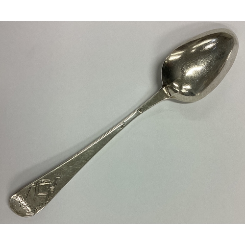 693 - An 18th Century silver spoon decorated with central armorial. Approx. 10 grams. Est. £20 - £30.