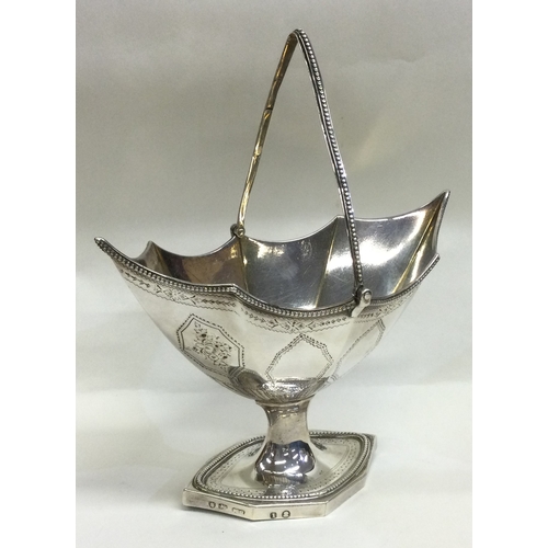 714 - An unusual shaped silver swing handled basket. London 1786. By Robert Hennell. Approx. 282 grams. Es... 